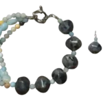 Handcrafted jewelry set featuring a three-line amazonite bead bracelet with large grey labradorite stones and matching silver hook earrings on a white background.