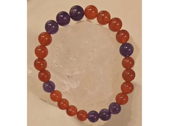 Handcrafted Carnelian and Amethyst gemstone bracelet featuring polished 8mm orange-red and purple beads, symbolizing protection from the evil eye, courage, balance, and spiritual harmony.