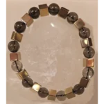 Handcrafted Smoky Quartz and Hematite bracelet featuring 8mm smoky quartz beads and metallic hematite cube beads displayed on a clear quartz crystal.
