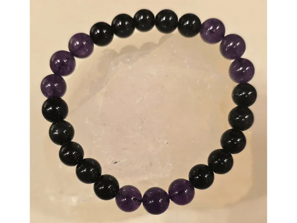 Handcrafted Obsidian and Amethyst gemstone bracelet featuring polished 8mm black and purple beads, symbolizing protection from the evil eye, grounding energy, wisdom, and inner peace.