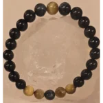 Handmade 8mm Obsidian, Tiger’s Eye, and Hawk’s Eye gemstone bracelet displayed on a clear quartz crystal, symbolizing protection, grounding, confidence, and evil eye defense.