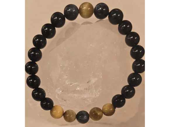Handmade 8mm Obsidian, Tiger’s Eye, and Hawk’s Eye gemstone bracelet displayed on a clear quartz crystal, symbolizing protection, grounding, confidence, and evil eye defense.