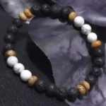 Handcrafted lava stone, howlite, and picture jasper bracelet with natural 6mm gemstone beads displayed on a dark textured background.